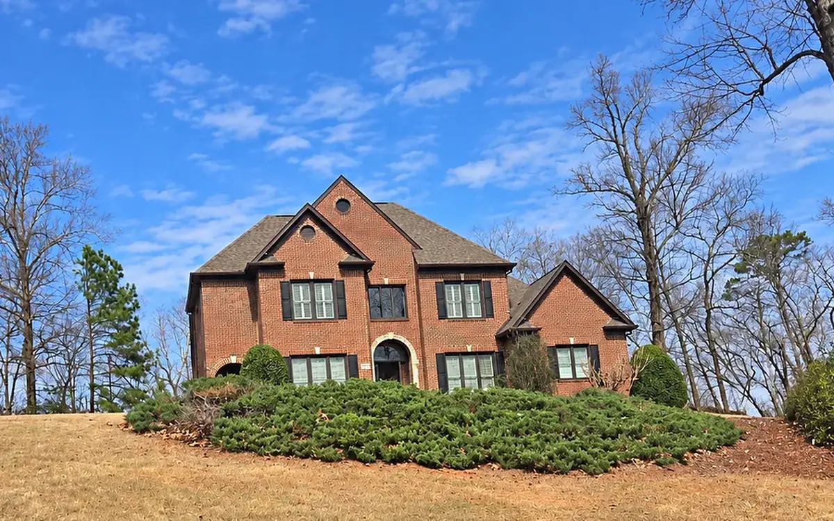 After: the same brick house with the trees removed