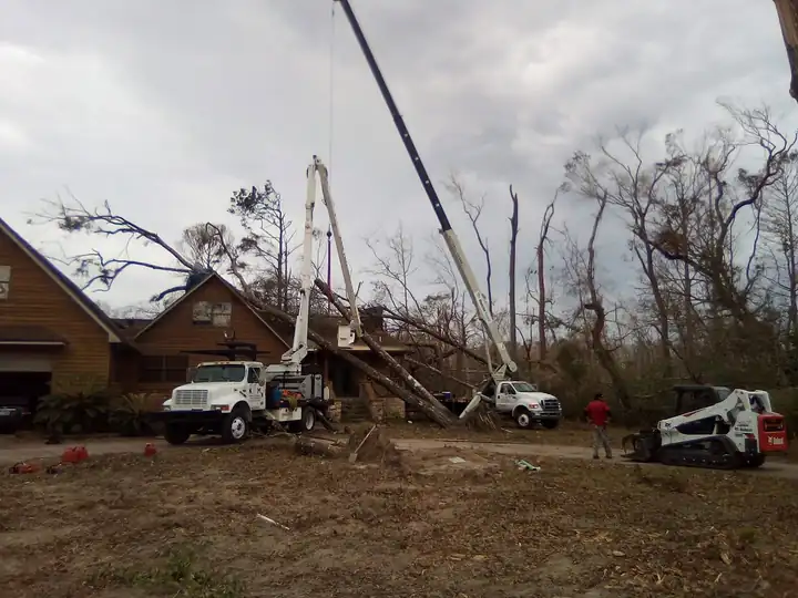 Storm cleanup with a crane, bucket truck, and skid steer
